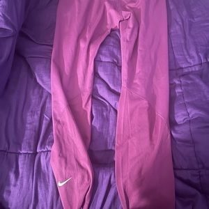 Tight purple NIKE pro pants.